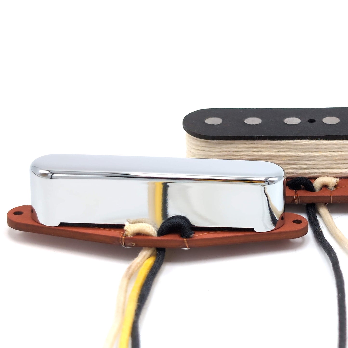 Close-up of the two pickups showing the chrome neck pickup cover and the red bottom flatwork