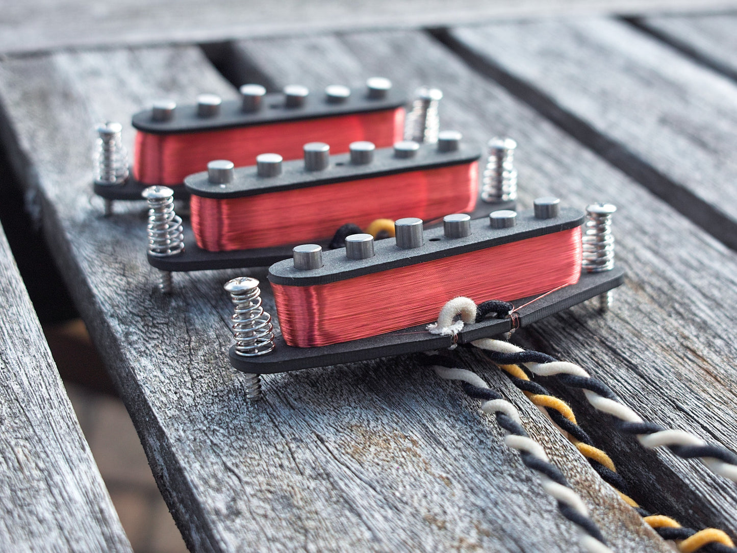 Three pickups for stratocaster with coils exposed. They have vintage staggered poles.