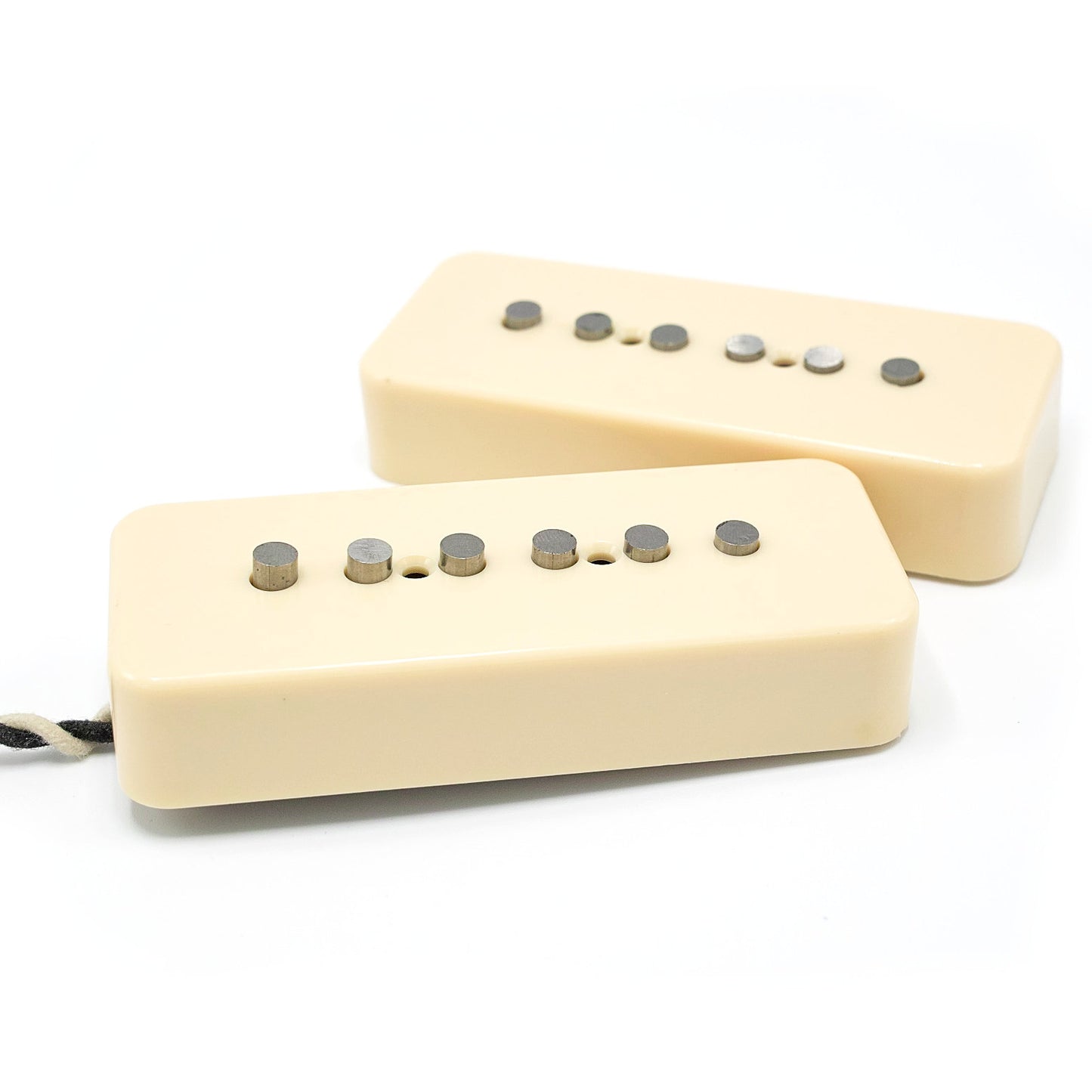 Two soapbar style pickups with alnico rod poles and ivory covers.