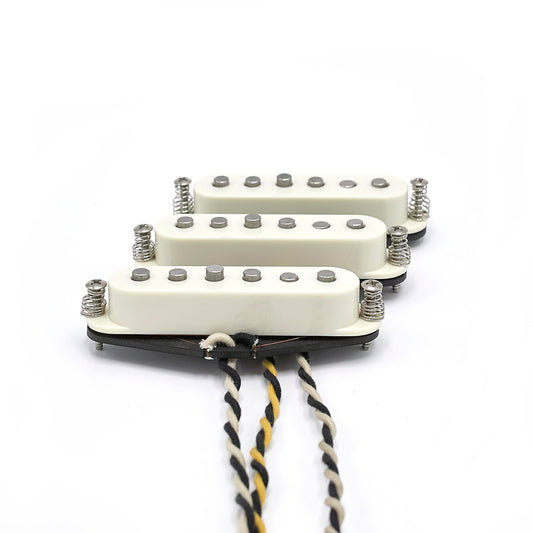 Three pickups for Stratocaster electric guitars with vintage staggered poles and parchment covers