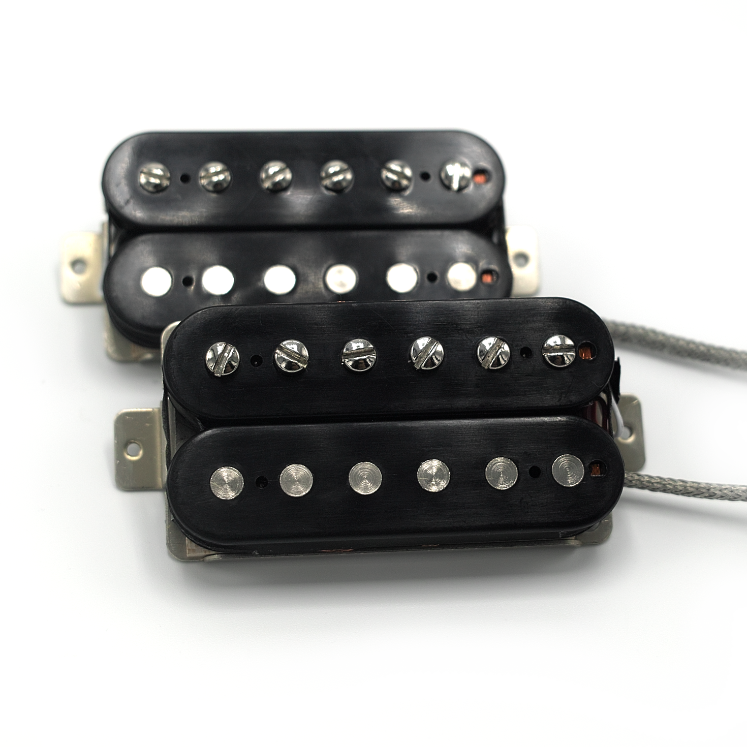 Two humbucker pickups with black bobbins and vintage style mesh lead wires