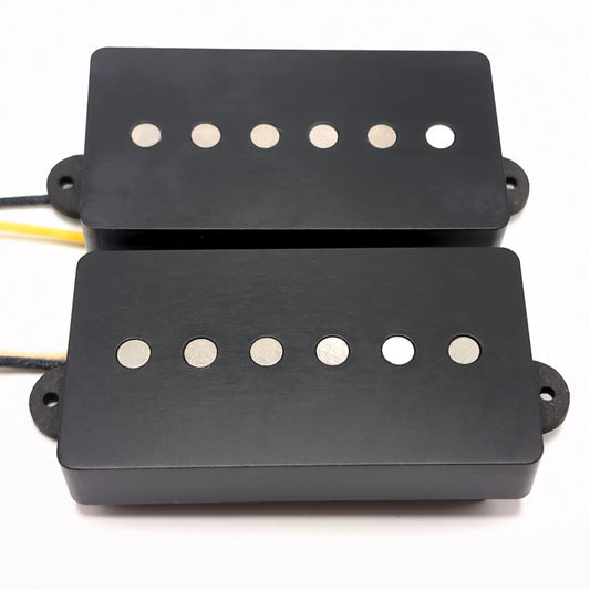 Two humbucker sized single coil pickups with black corian covers