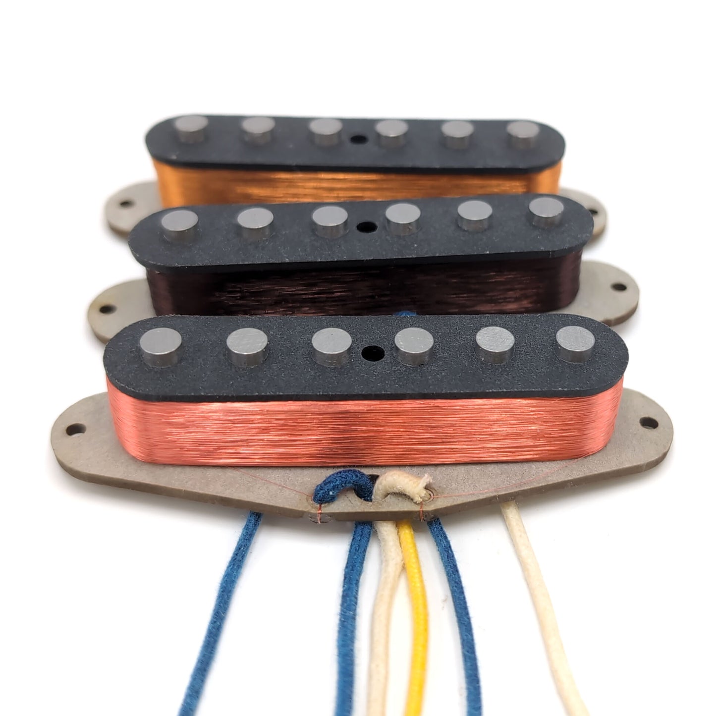 3 pickups for stratocaster style guitars with gray bottom flatwork and black top flatwork.