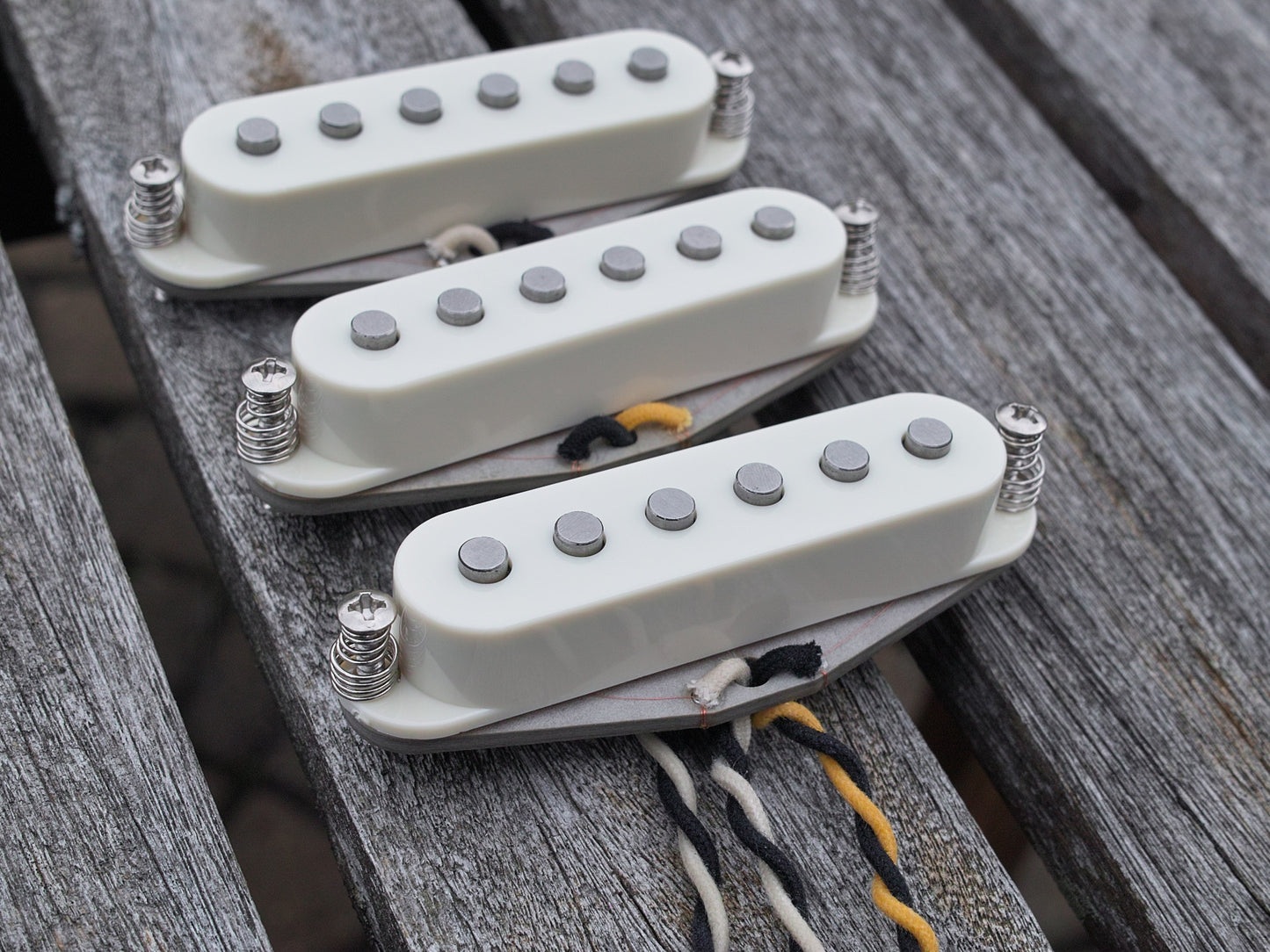 Three pickups for stratocaster with parchment covers. They have flat poles.