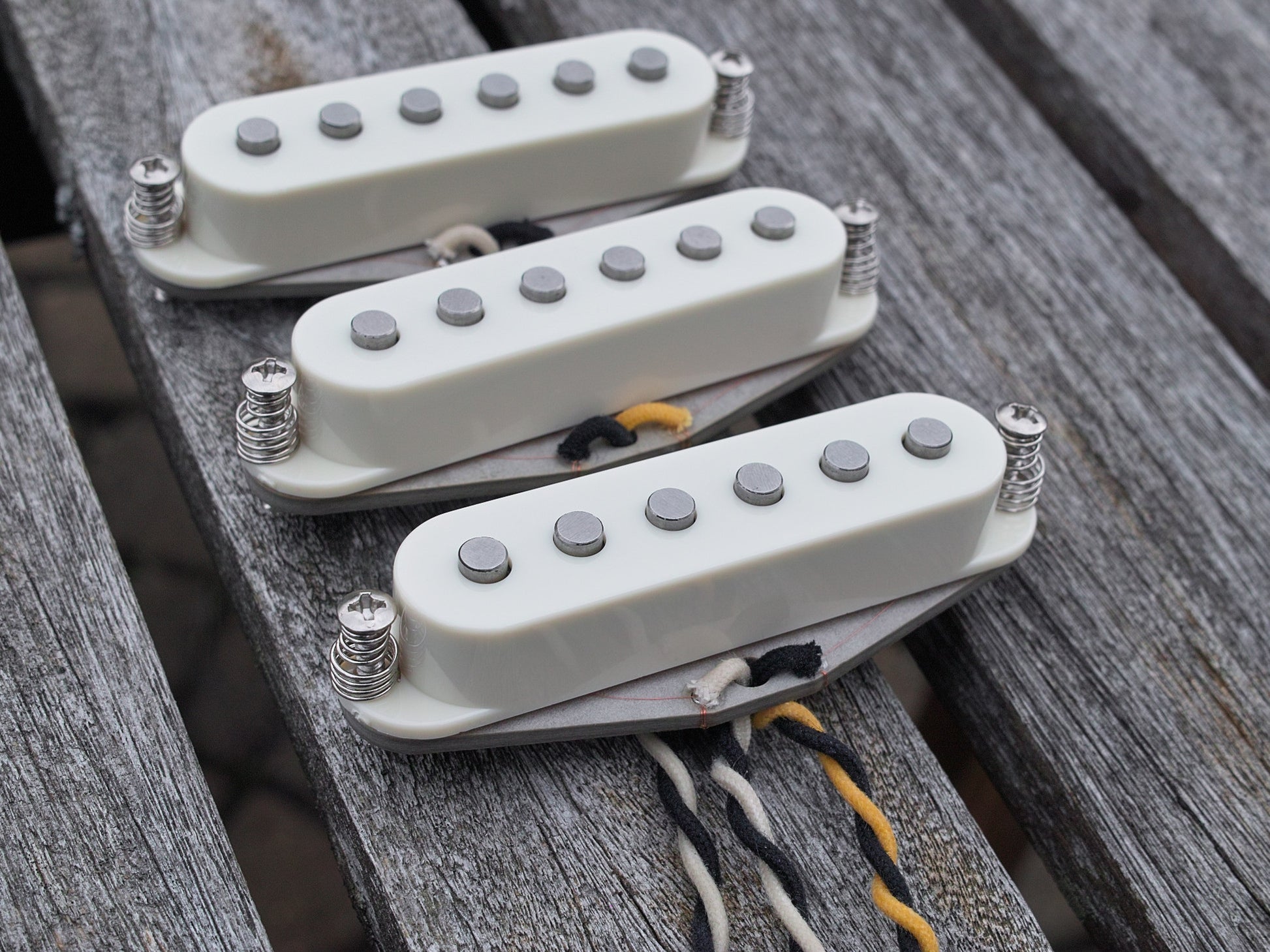Three pickups for stratocaster with parchment covers. They have flat poles.
